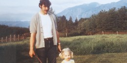 Father giving daughter wheelbarrow ride