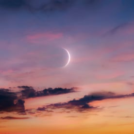 New Moon in the sky at sunset.