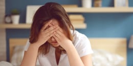 Unhappy woman in a bedroom